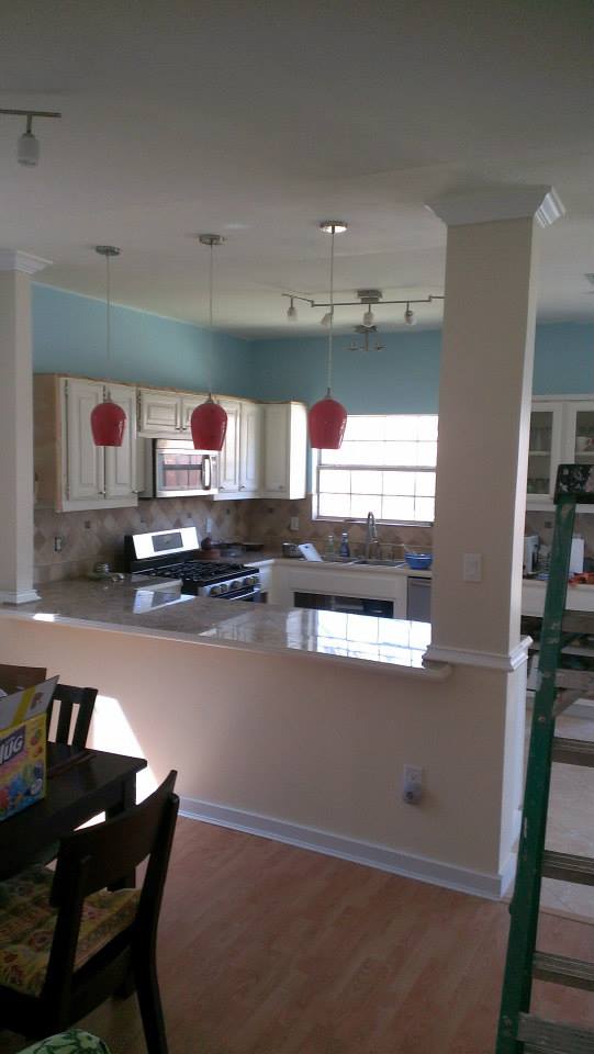 Seamless After picture of open floor plan connecting kitchen and dining room by The Contractor INC